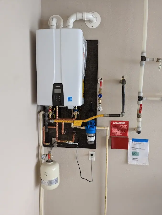 Professional plumber installing copper piping in a Tishomingo home